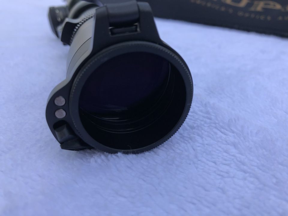 Close-up of the objective lens housing of an optical scope