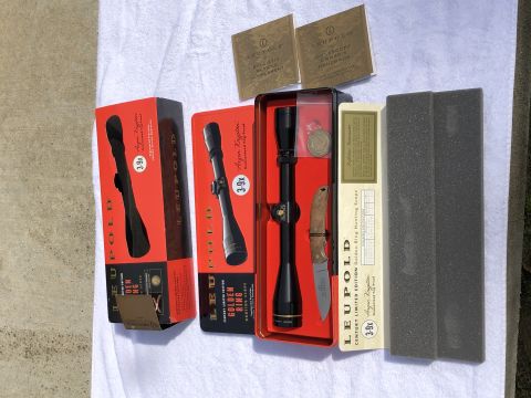 1995 Mercury Grand Marquis - Collection of Leupold rifle scopes, a knife, and documentation are laid out on a white surface.