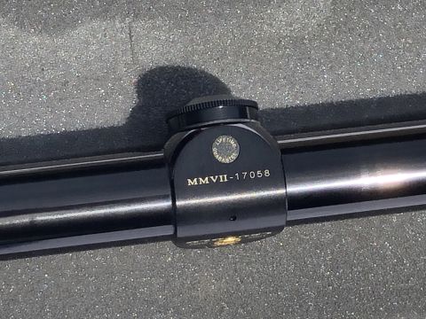 1995 Mercury Grand Marquis - A close-up view of a scope mount, showing engraved text and a guarantee emblem.