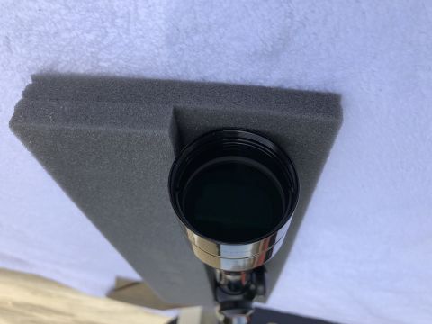 1995 Mercury Grand Marquis - Close-up of a telescope eyepiece with its cap, resting on foam.