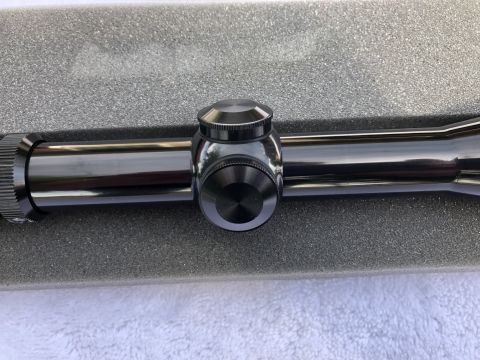 1995 Mercury Grand Marquis - A close-up view of a gun scope, not a 1995 Mercury Grand Marquis, is presented on a foam base.