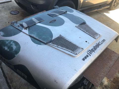 1992 Jeep Wrangler - Hood for a Jeep Wrangler with a custom camouflage paint job and a website address printed on the side.