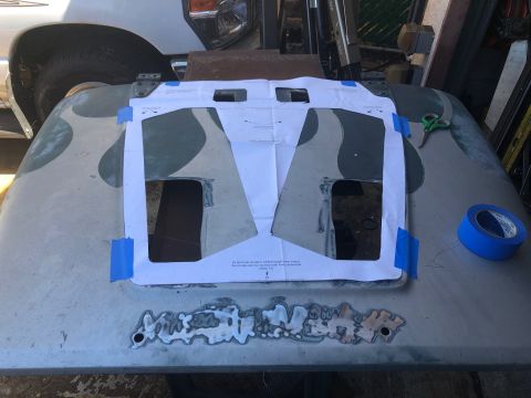 1992 Jeep Wrangler - Paper template is taped to a vehicle hood for cutting. Tools and tape are visible.