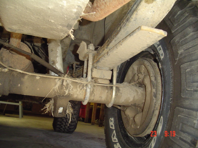 1989 Ford Bronco rear axle with leaf spring suspension and part of the tire visible