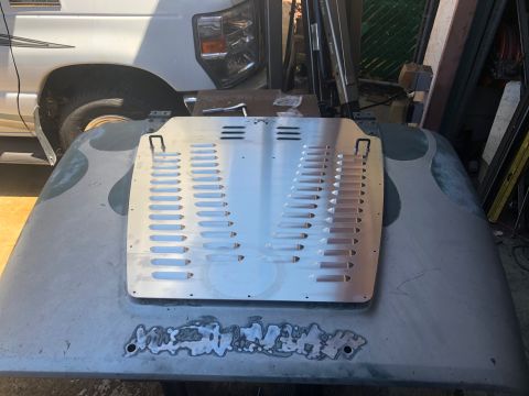 1992 Jeep Wrangler - An aluminum hood louvered vent panel is placed on a gray hood that has flame decals and visible bodywork repairs.