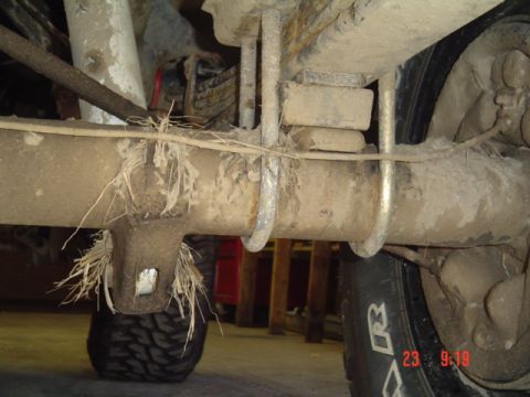 1989 Ford Bronco - This photo shows the rear axle and suspension components of a vehicle, with visible U-bolts and leaf springs.
