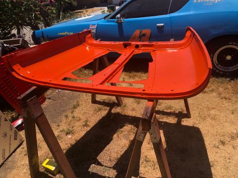 1992 Jeep Wrangler - Orange car hood on sawhorses with a blue Dodge Charger in the background.