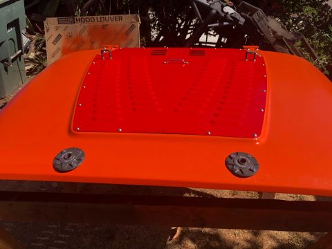 1992 Jeep Wrangler - Orange hood with a red louvered insert and two black latches is shown.