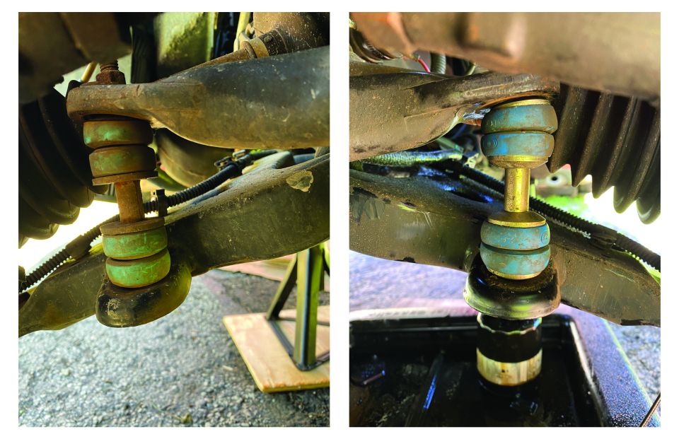 Close-up of vehicle suspension sway bar end links with green and blue bushings.