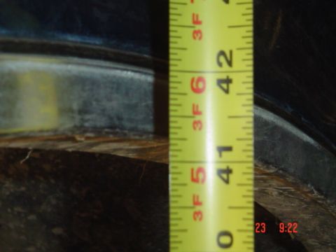 1989 Ford Bronco - A measuring tape is used to gauge a measurement on the vehicle's frame, indicating approximately 41 inches.