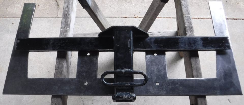 Chopped up Curt 13310 laid over the winch plate.  The horizontal edge of the old square tubing needs to be trimmed further back, as I added the rear lip that boxes in the winch plate's cutouts.  The winch plate is symmetric side-to-side, so what's shown as the top will become the bottom.