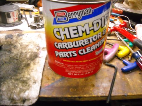 1992 Jeep Wrangler - A can of Berryman Chem-Dip Carburetor and Parts Cleaner sits on a workbench next to various tools and a dirty rag. The can is red, yellow,…