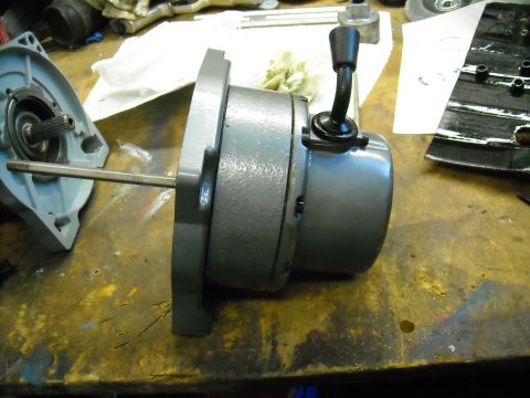 1992 Jeep Wrangler - A gray painted automotive gearbox assembly is shown connected to a motor with a shift lever. A separate light blue housing with a splined s…