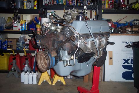 1978 Ford Bronco - A Ford V8 engine, likely from the late 1970s or early 1980s, is mounted on a red engine stand in a garage setting. The engine features a gr…