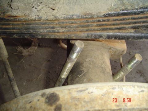 1989 Ford Bronco - Detail of vehicle suspension components, showing leaf springs and bolts on an axle.