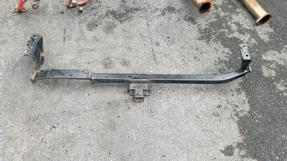 Black trailer hitch receiver on asphalt