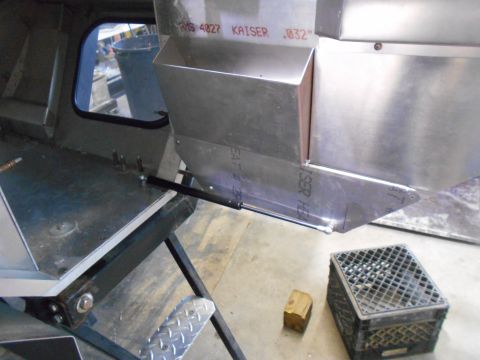 1992 Ford Bronco - A close-up view of the interior of a vehicle build, showing custom metal fabrication including a bin with text that reads "KAISER .032" and…