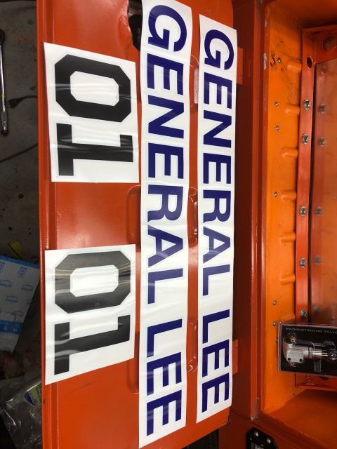 1992 Jeep Wrangler - Two sets of decals are shown on an orange surface. One set has the numbers "01" and the other has the text "GENERAL LEE".