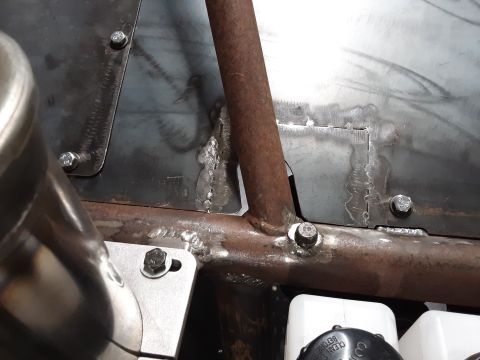 1985 Toyota Hilux - Close-up view of welds and bolts on a metal frame, likely part of a custom vehicle build. The raw metal and visible fabrication suggest a f…