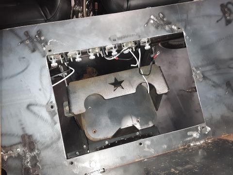 1985 Toyota Hilux - A close-up view of a custom metal fabrication project, likely for a vehicle interior, with visible wiring and a metal component featuring a…