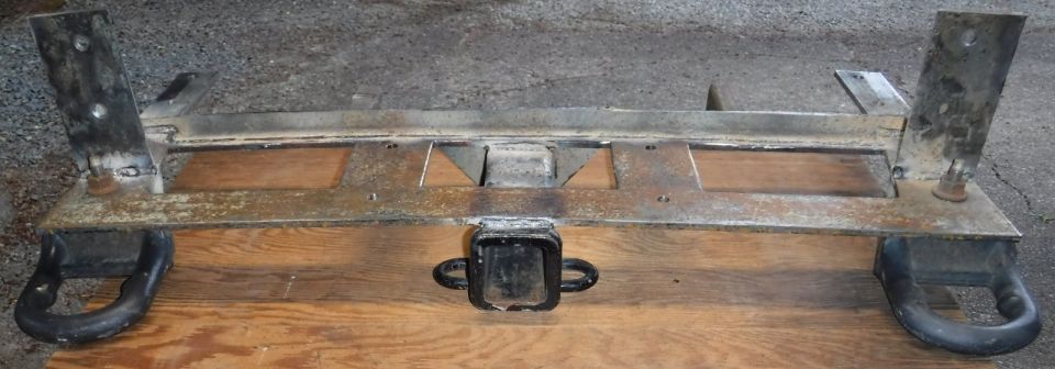 Receiver added in and all spot welds filled in fully ... only to realize after that the main plate had developed quite a bow.  It warped exactly 1/2" at both ends, meaning the bumper bracket holes no longer line up.  Ugh.