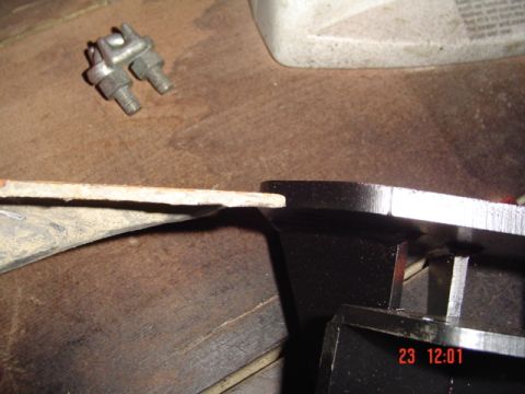 1989 Ford Bronco - Close-up of a metal bracket and hardware, likely for vehicle suspension modification.