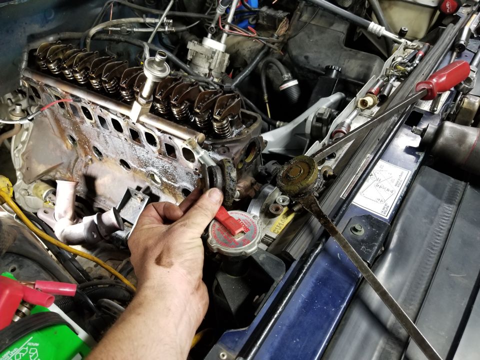 Engine with intake manifold removed showing valve springs, rockers and bare head deck