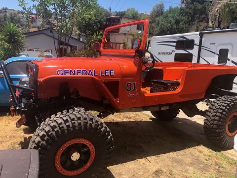 1992 Jeep Wrangler - A lifted, bright orange Jeep Wrangler, nicknamed "General Lee," is parked outdoors in a residential area. The vehicle features large off-ro…