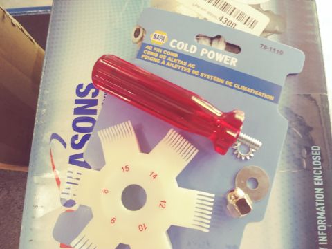 1996 Ford Bronco - A NAPA Cold Power AC fin comb tool and a set of assorted nuts and washers are laid out on top of a blue and white box with "SEASONS" printe…