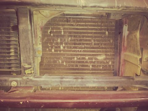 1996 Ford Bronco - This is a close-up view of the front of a vehicle's radiator and condenser assembly. The fins of the radiator are visible, along with some…