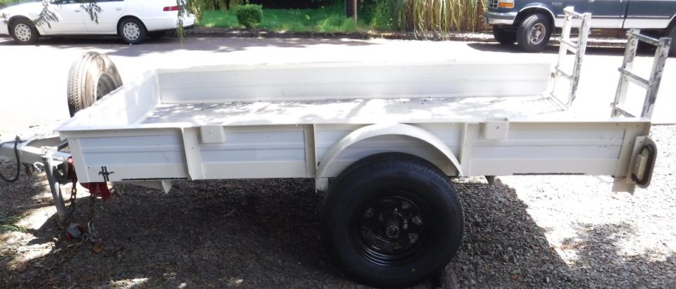 Mostly done improving and repainting the trailer.  Solid sides added for hauling dirt and gravel, stake pockets built into the upper rail for full, loose loads.  Spare tire moved up top (was below the bed) to be more accessible.