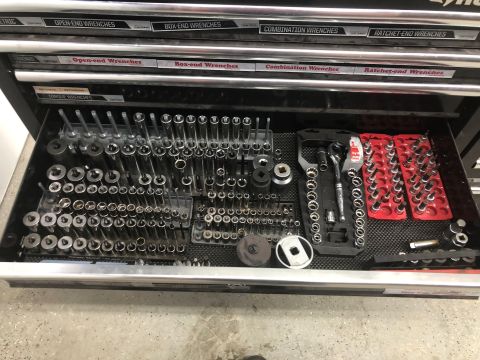 1992 Jeep Wrangler - A top-down view of an open tool drawer filled with various sockets and wrenches. The drawer is labeled with categories like "Open-end Wrenc…