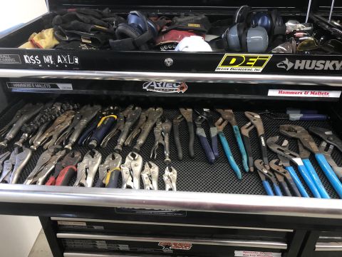 1992 Jeep Wrangler - A mechanic's tool chest drawer is filled with various pliers and wrenches. The tools are neatly organized on a black textured mat.