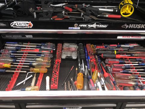 1992 Jeep Wrangler - A top-down view of a mechanic's tool chest drawer filled with screwdrivers and other tools. The drawer is organized with red racks holding…