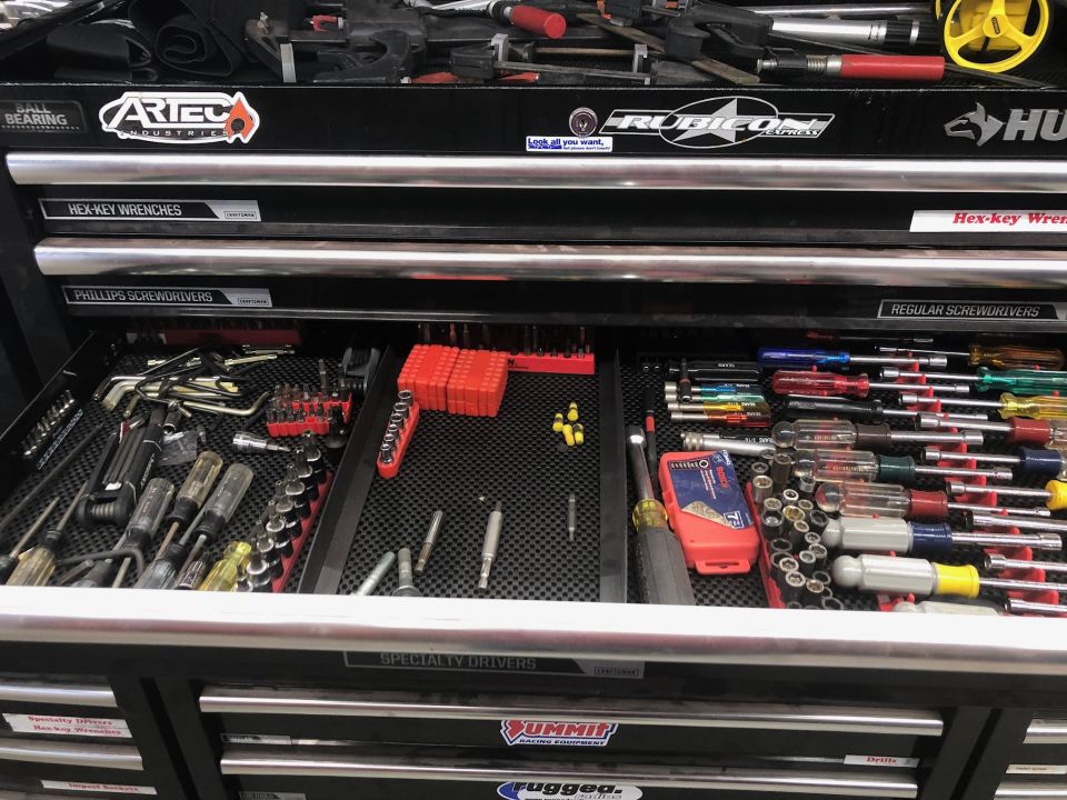 Toolbox drawer with screwdrivers and hex wrenches.