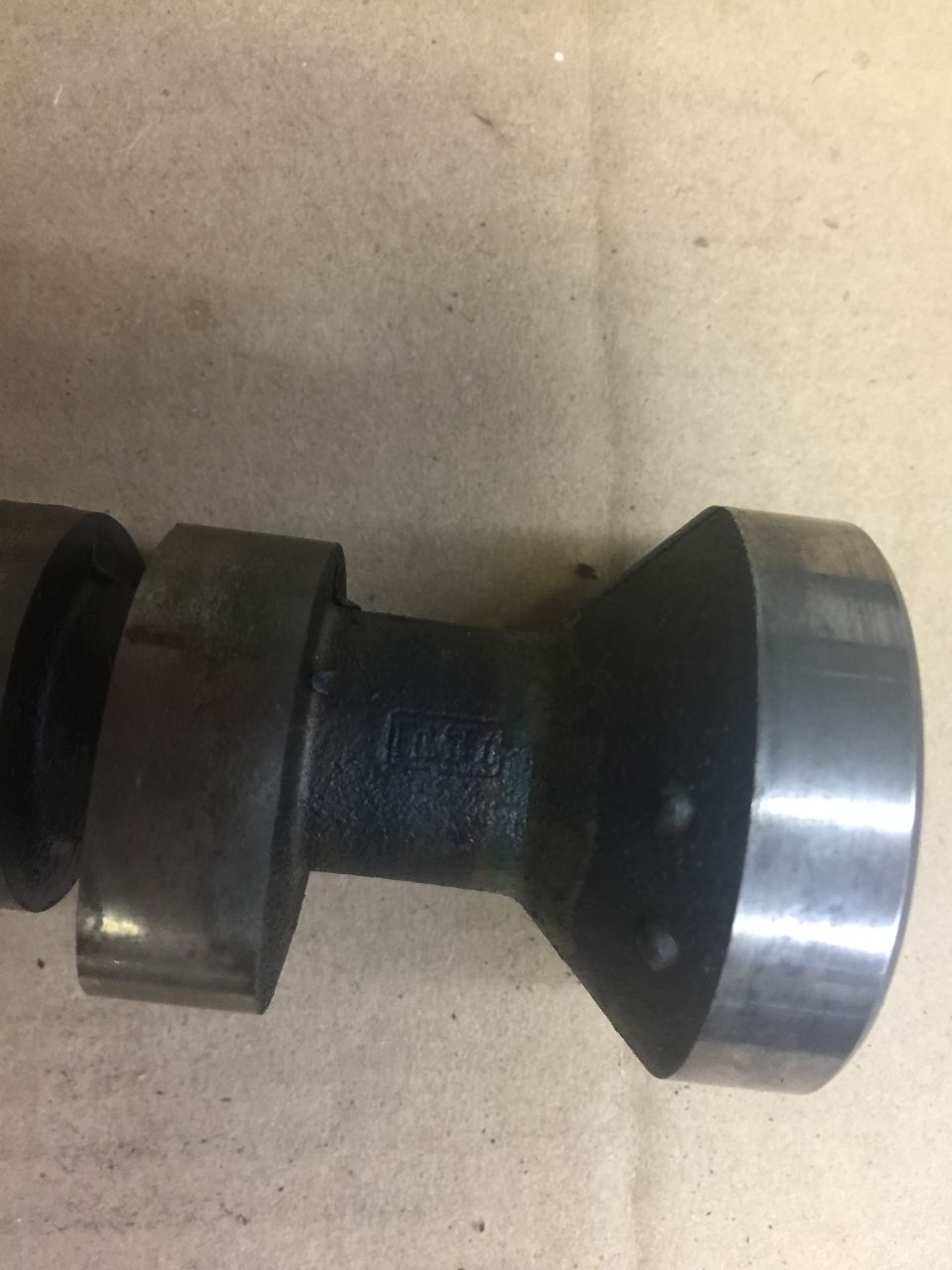 Close-up of a Ford camshaft with a stamped logo