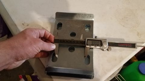 1985 Ford Bronco - A digital caliper measures the width of a metal bracket, displaying a reading of 3.000 inches. The bracket has several holes and appears to…