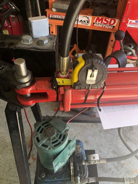 1992 Jeep Wrangler - A close-up shot shows a hydraulic cylinder with a tape measure indicating a measurement of 1 inch. A green electric motor and a blue hydrau…