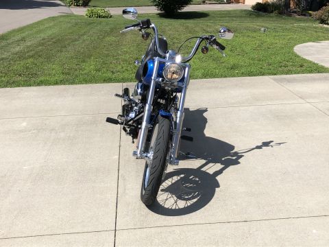2008 Harley-Davidson Softail - A blue motorcycle is parked on a concrete driveway, viewed from the front.