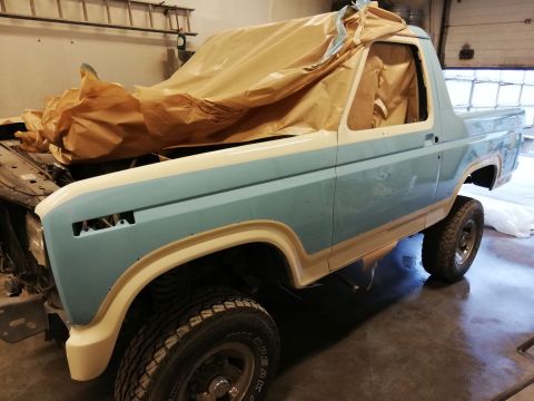 1996 Ford Bronco - This classic Ford Bronco is being prepped for paint, with its front end covered and the body showing two-tone colors.