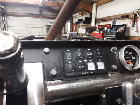 1985 Toyota Hilux - Interior view of a custom dashboard auxiliary switches and a gauge.