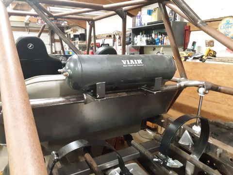 1985 Toyota Hilux - Interior view of a custom vehicle build, showing an installed VIAIR air tank and roll cage structure.