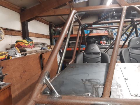 1985 Toyota Hilux - Interior view of a custom-built off-road buggy, a prominent roll cage and two bucket seats.