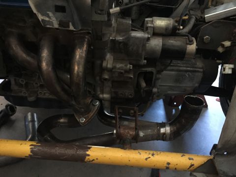 1993 Mercury Tracer - Close-up view of an engine's exhaust manifold and associated components.