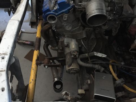 1993 Mercury Tracer - Close-up view of an engine bay, focusing on the engine components including the valve cover and starter motor.