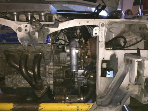 1993 Mercury Tracer - Close-up view of a modified engine bay, showing a turbocharger and exhaust components.