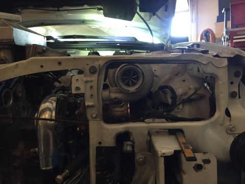1993 Mercury Tracer - Close-up view of a turbocharger and intercooler piping installed in a vehicle's engine bay.