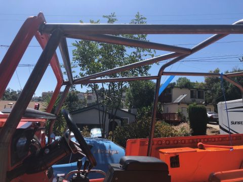 1992 Jeep Wrangler - The interior of an off-road vehicle is visible, dominated by a custom metal roll cage structure.
