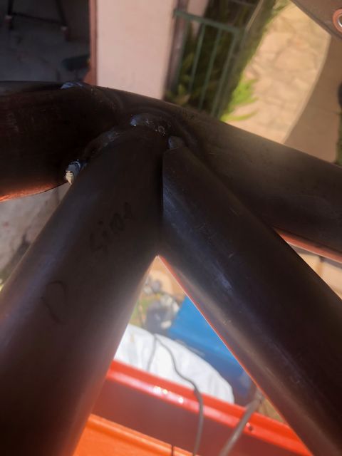 1992 Jeep Wrangler - Close-up view of welded metal tubing, possibly part of a roll cage or frame, with the handwritten word "Side" visible on one of the tubes.