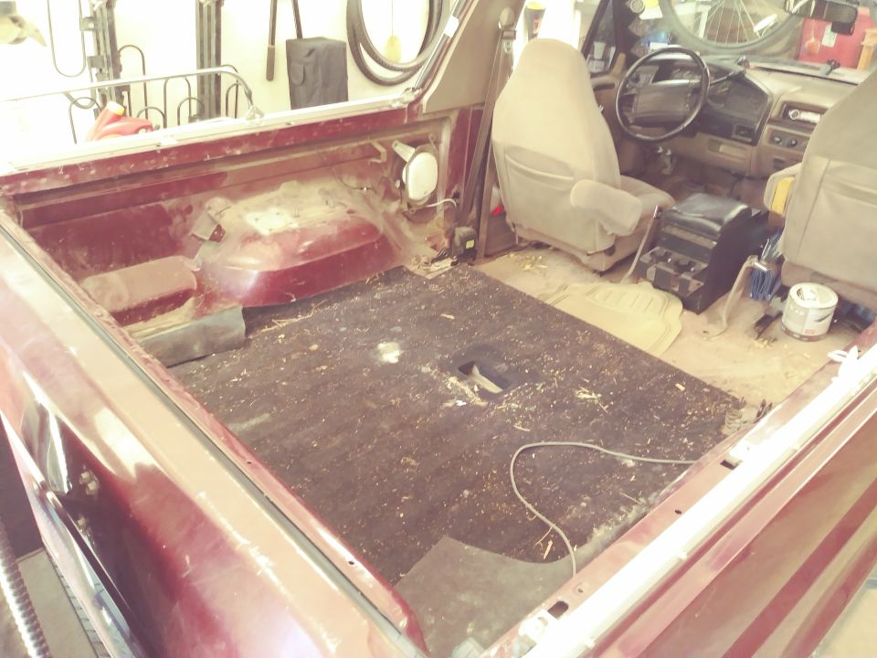 Interior and rear bed of a maroon Ford Bronco.